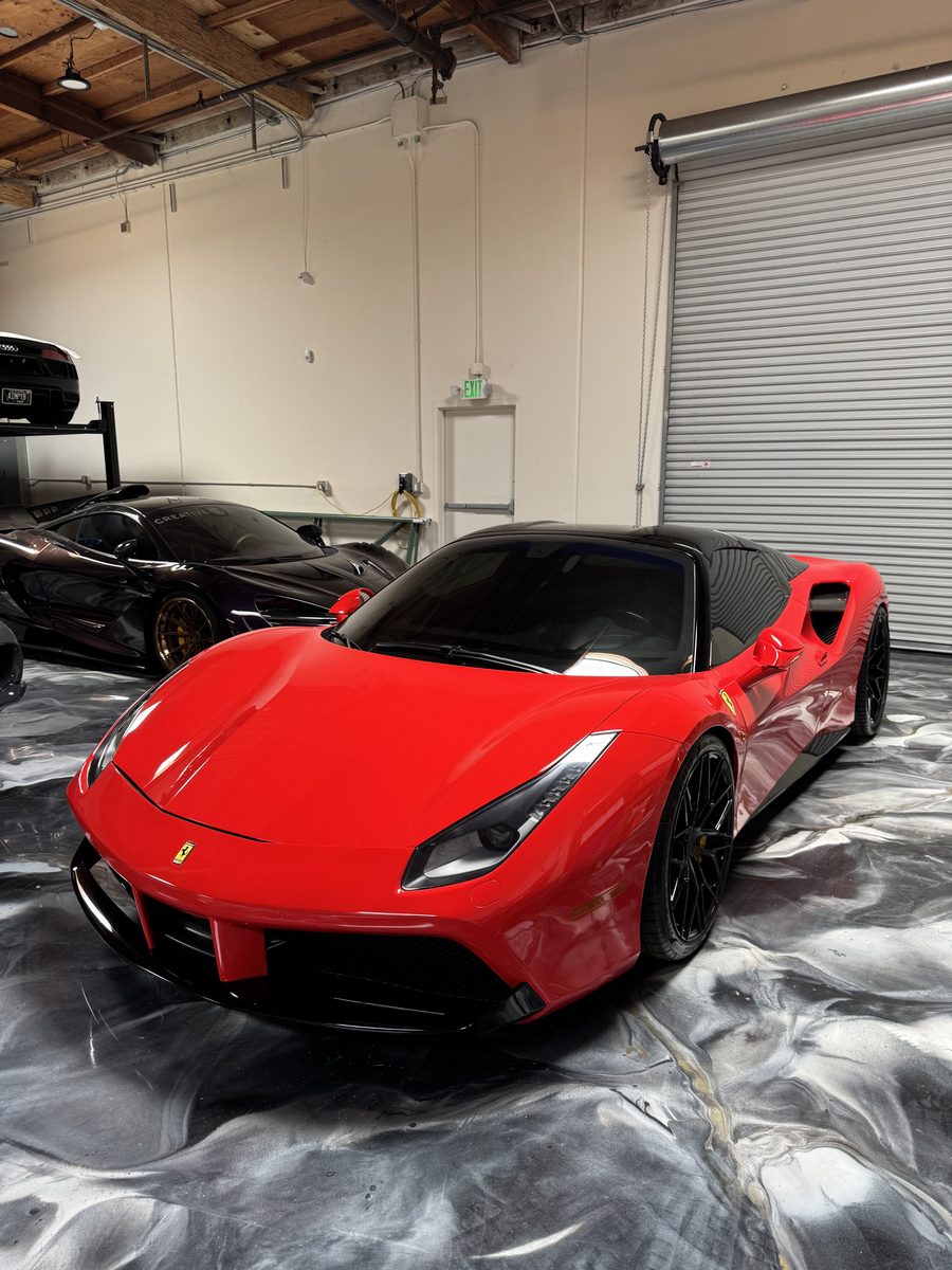 Red Ferrari 488 on silver metallic epoxy floor